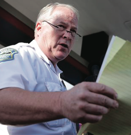 In this Aug. 15, 2014 file photo, Ferguson Police Chief Thomas Jackson releases the name of the officer accused of fatally shooting Michael Brown in Ferguson, Mo. On Friday, March 6, 2015, Jackson is still on the job, two days after a government report criticized his department for years of racial profiling. (AP Photo/Jeff Roberson)