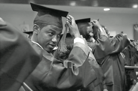 In this May 5, 2014 photo, Krishaun Branch, left, moves the tassel on his mortarboard to the left side after graduating from Fisk University in Nashville, Tenn. (AP Photo/Mark Humphrey)