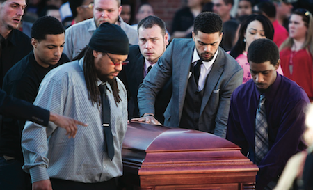 Uncle Turin Carter, centre, and pallbearers wheel the casket of Tony Terrell Robinson, Jr. during his funeral at Madison East High School. (Photo by Reuters)