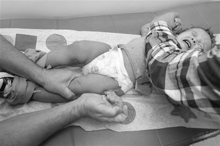 Pediatrician Charles Goodman vaccinates 1 year-old Cameron Fierro with the measles-mumps-rubella vaccine, or MMR vaccine at his practice in Northridge, Calif., Thursday, Jan. 29, 2015. (AP Photo/Damian Dovarganes)