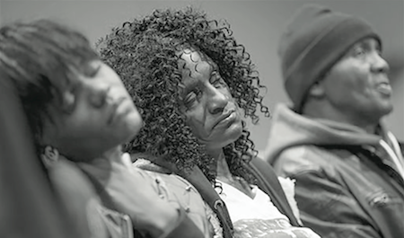 Family members of Freddie Gray, sister Fredricka Gray, left, mother Gloria Darden, center, and stepfather Richard Shipley listen during a news conference after a day of unrest following the funeral of Freddie Gray on Monday, April 27, 2015, in Baltimore. Rioters plunged part of Baltimore into chaos torching a pharmacy, setting police cars ablaze and throwing bricks at officers. (AP Photo/Evan Vucci)