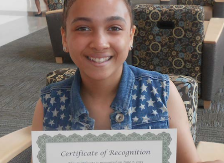 A recent Links program participant presents her certificate.